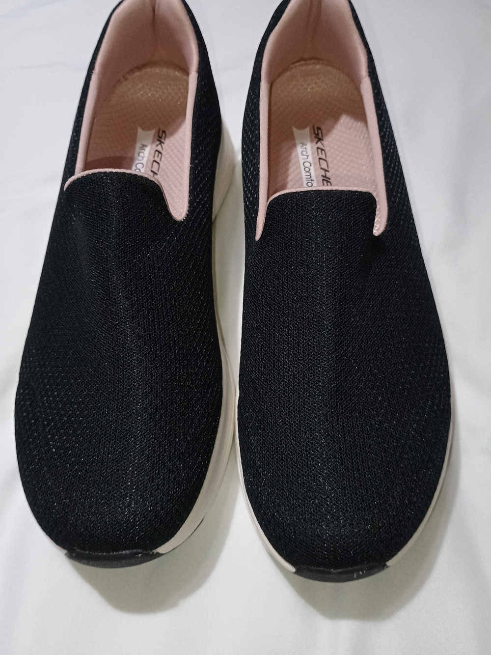 Skechers Women's Black Slip-On Sneakers with Pink Lining